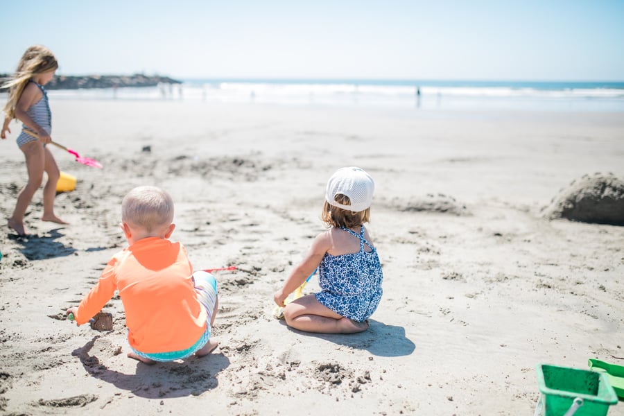 children playing on oceanside beach california