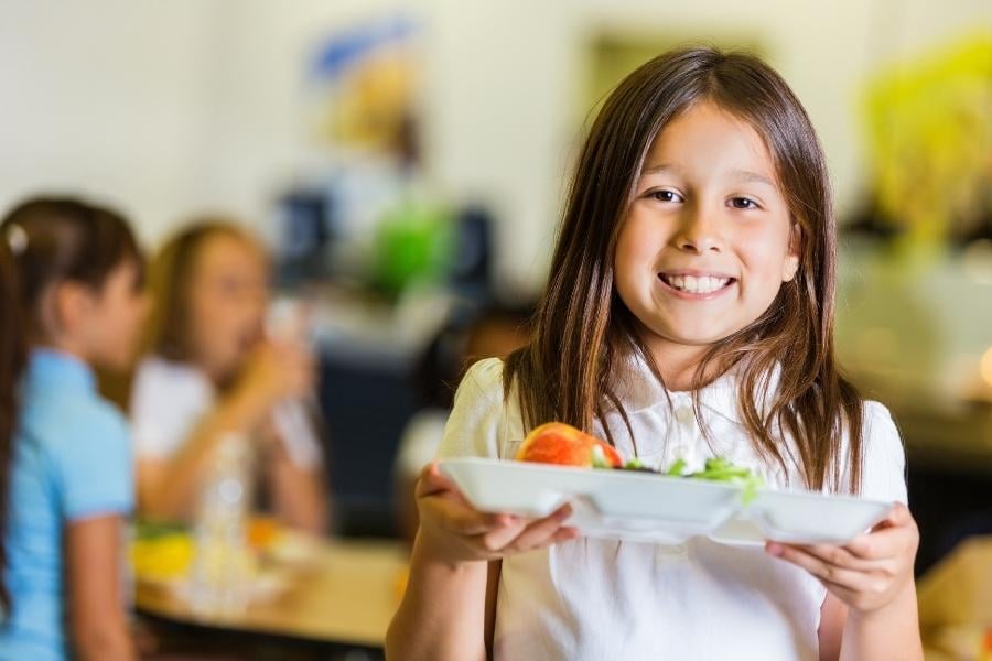 girl with tray in school cafeteria