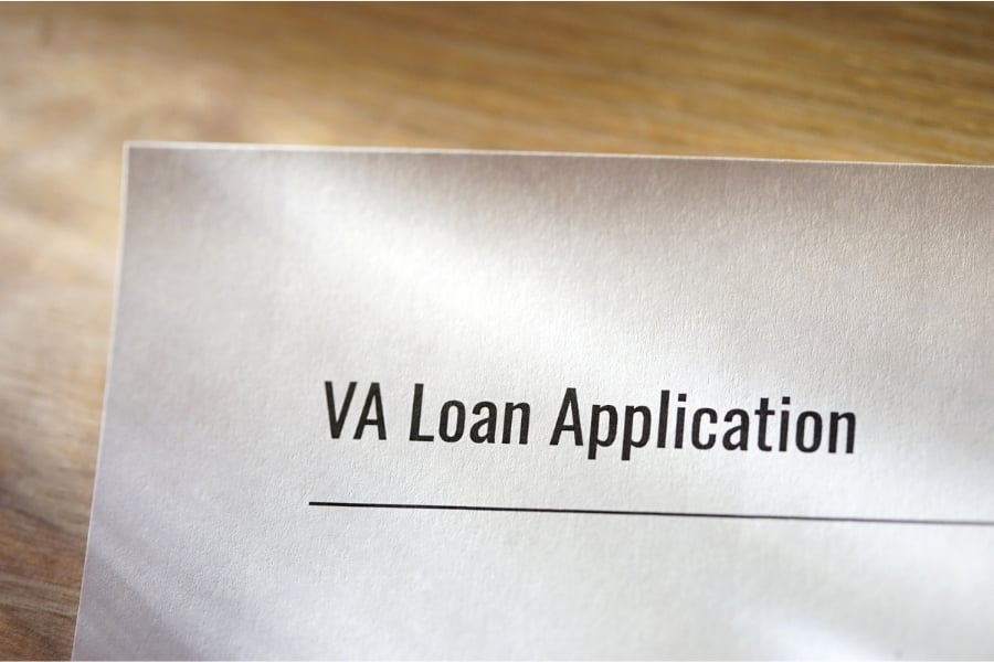 sheet of white paper on wooden table with words VA loan application 