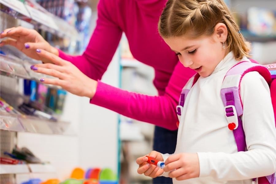 young girl and mom shopping for back to school supplies