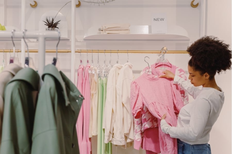 woman looking at clothes while shopping