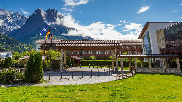 Edelweiss Lodge and Resort wooded lodge with mountains and blue sky