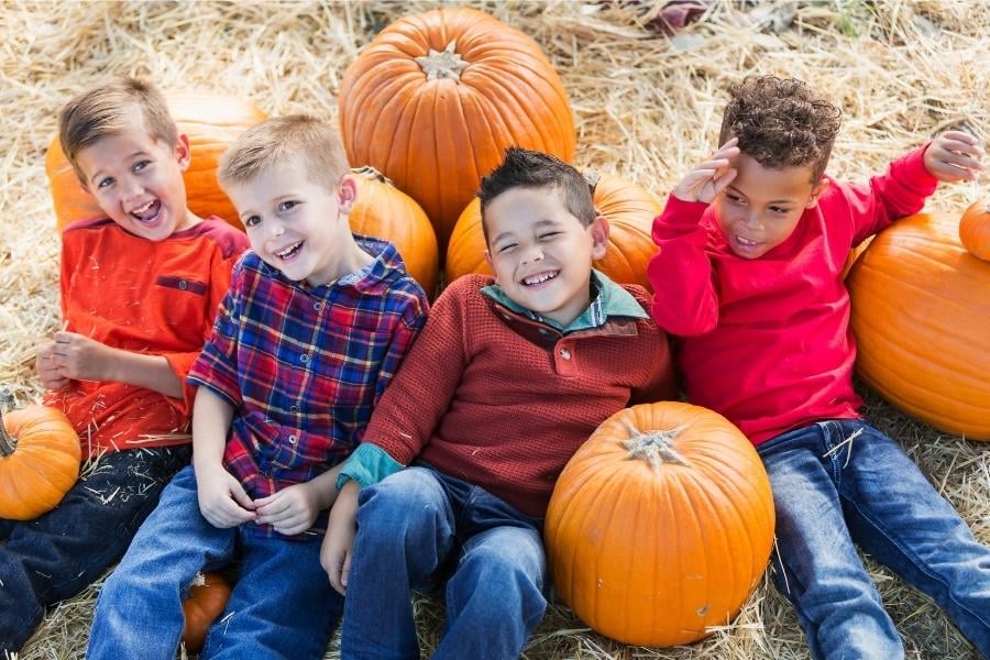 young children in pumpkin patch