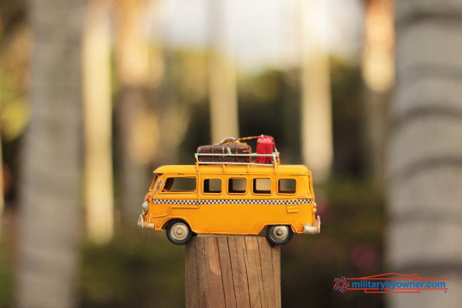 miniature bus sitting on wooden post
