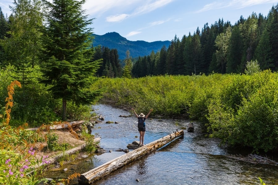 woman standing in creek at Cascade Mountains near JBLM