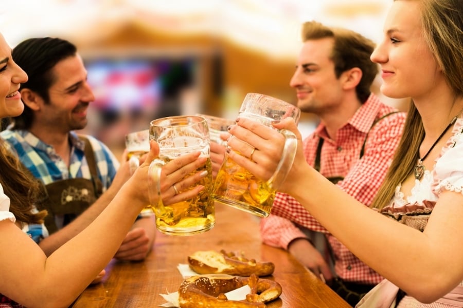 People in traditional German clothing with beer steins 