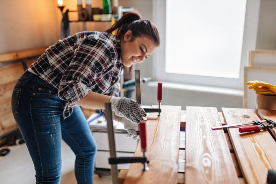 Woman with brace and planks of wood in home renovation project