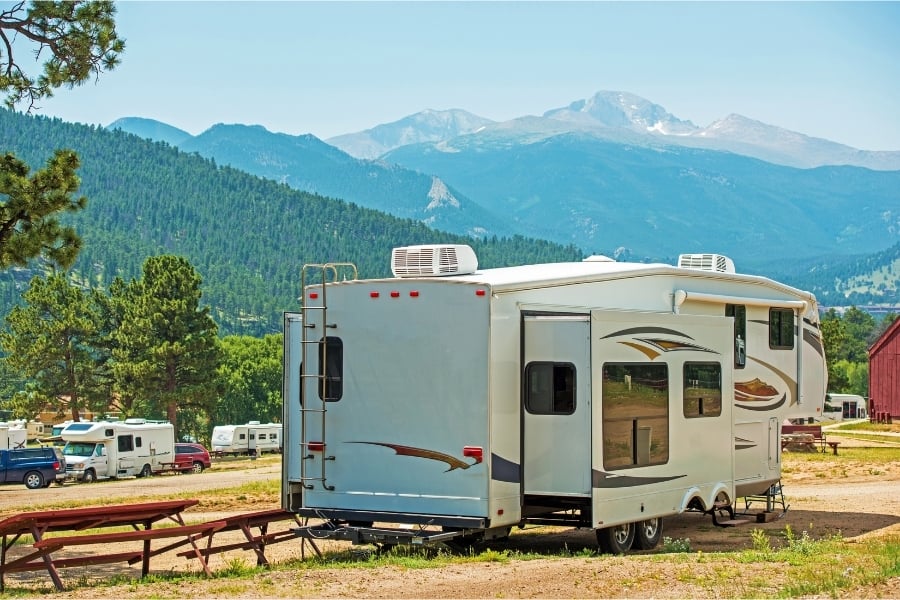 RV with pop outs parked near Colorado mountains
