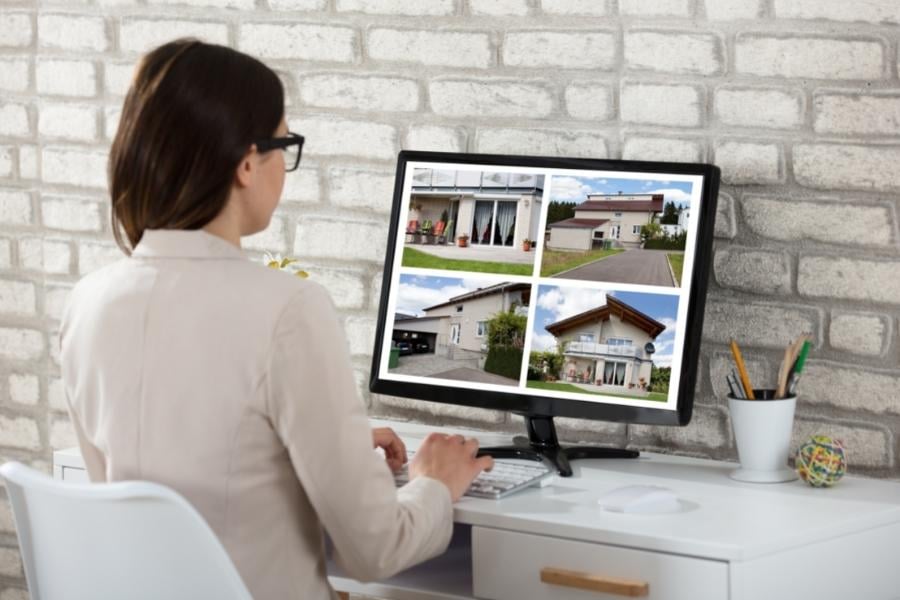 woman at laptop looking at homes