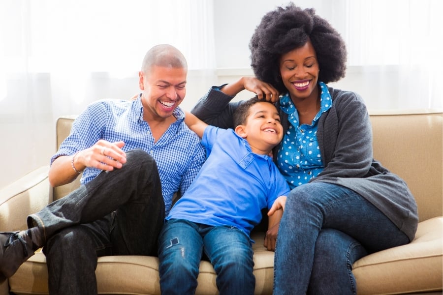 couple sitting on couch with child