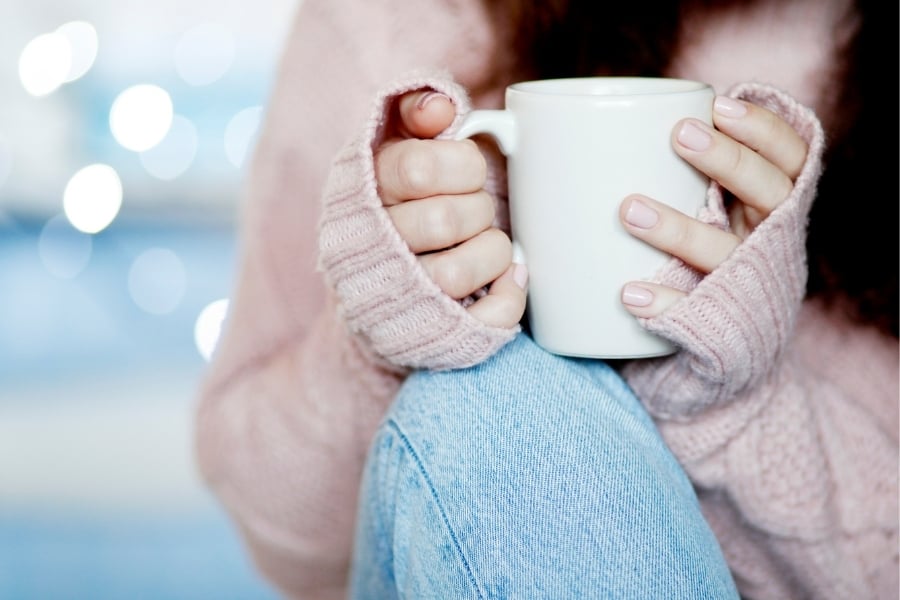 woman holding coffee cup