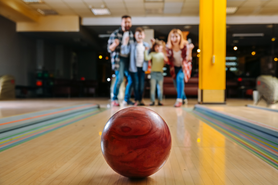 Family at bowling alley with bowling ball
