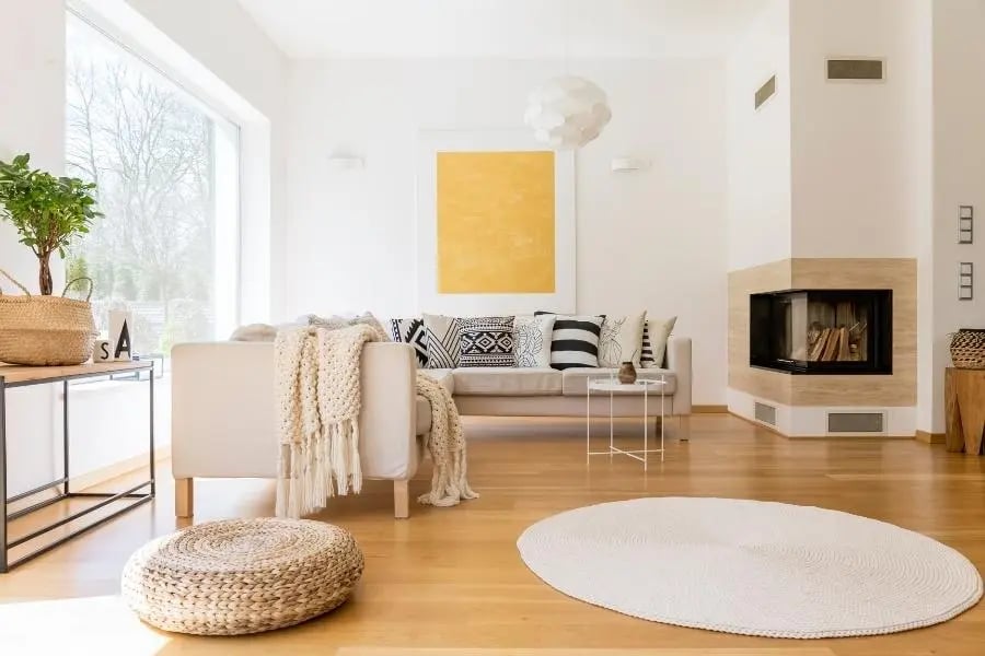 home with wooden floor, rug, and pouf