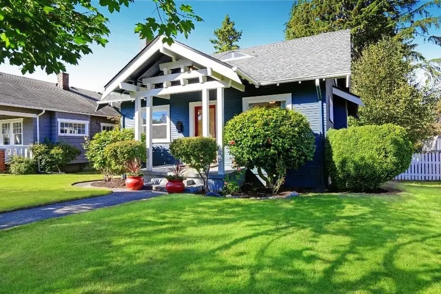 blue home exterior with green lawn