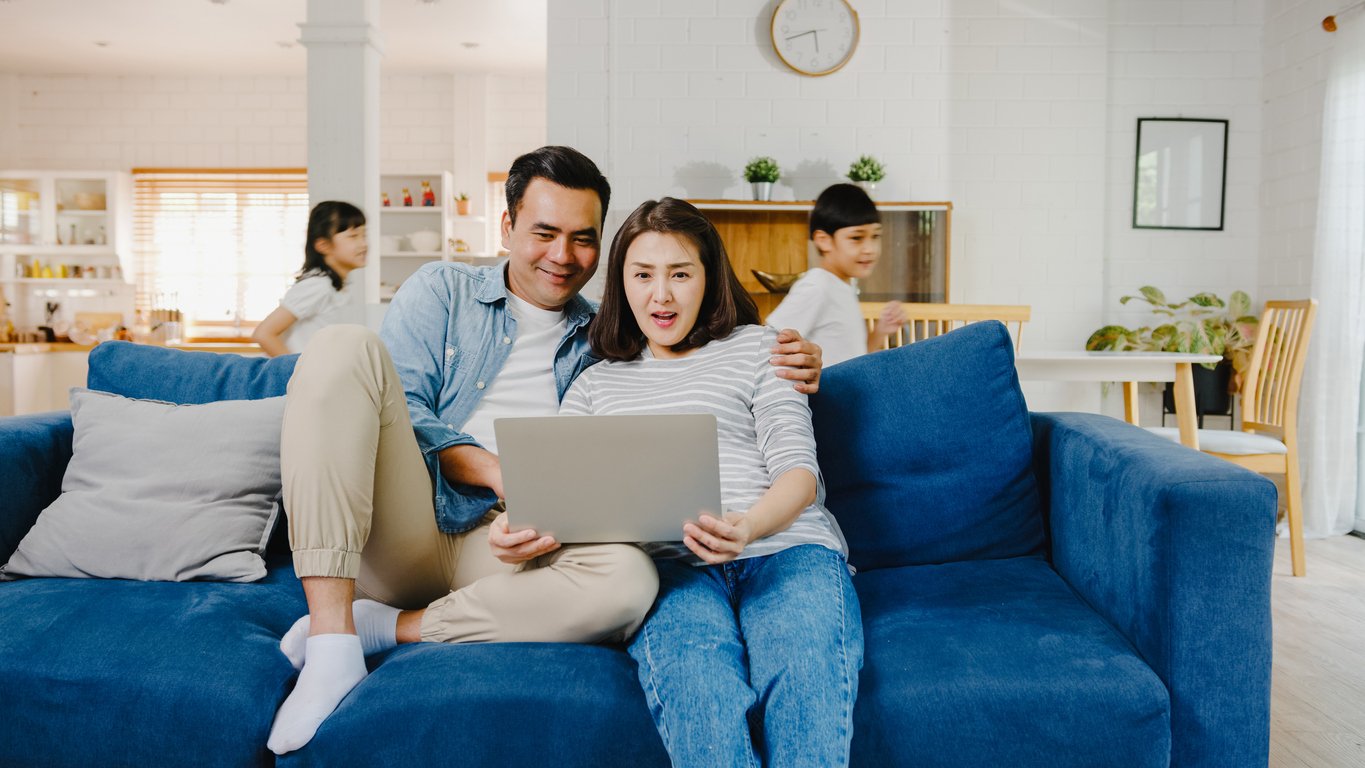 military family at home looking at laptop
