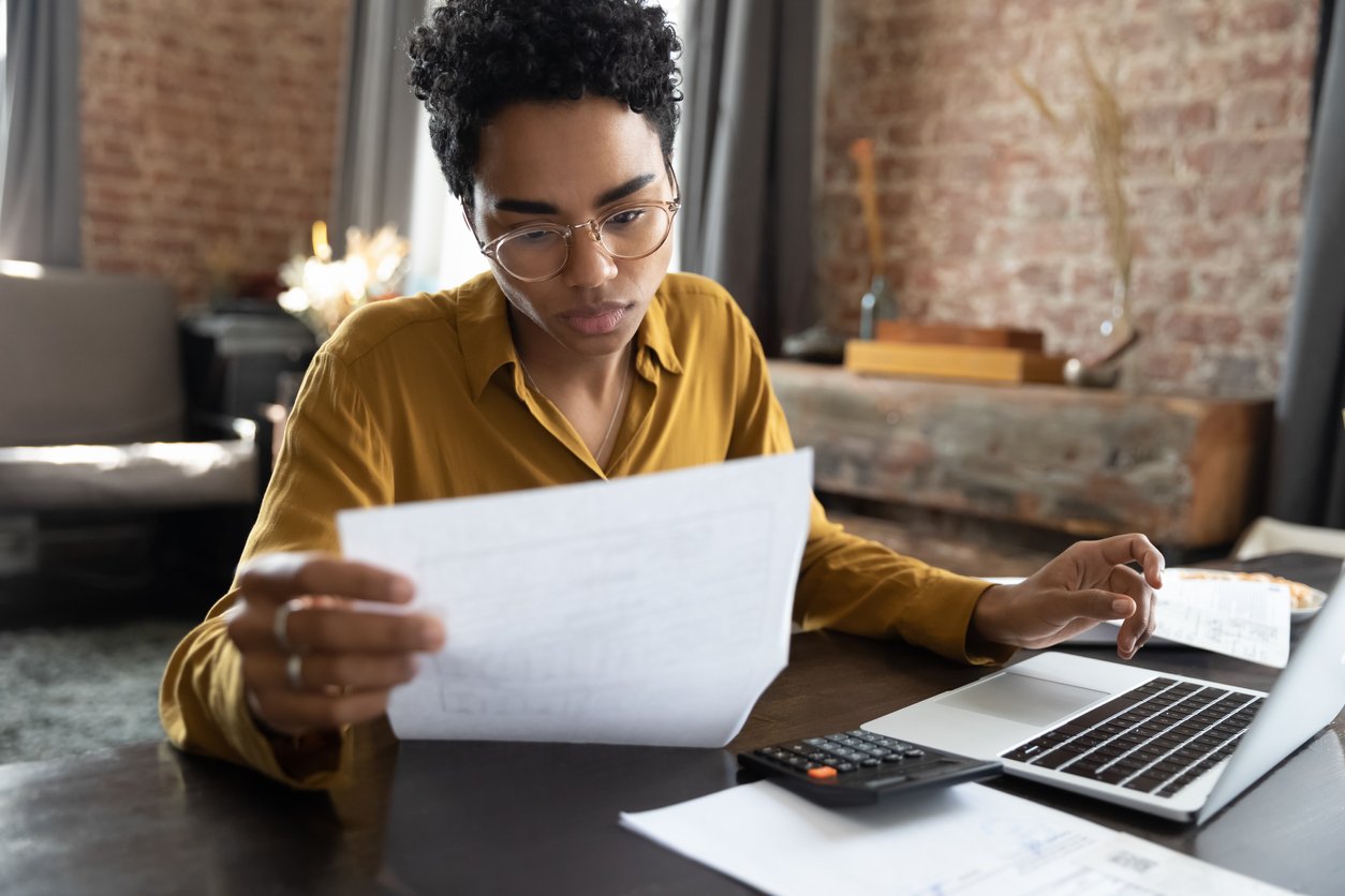 woman with papers laptop and calculator