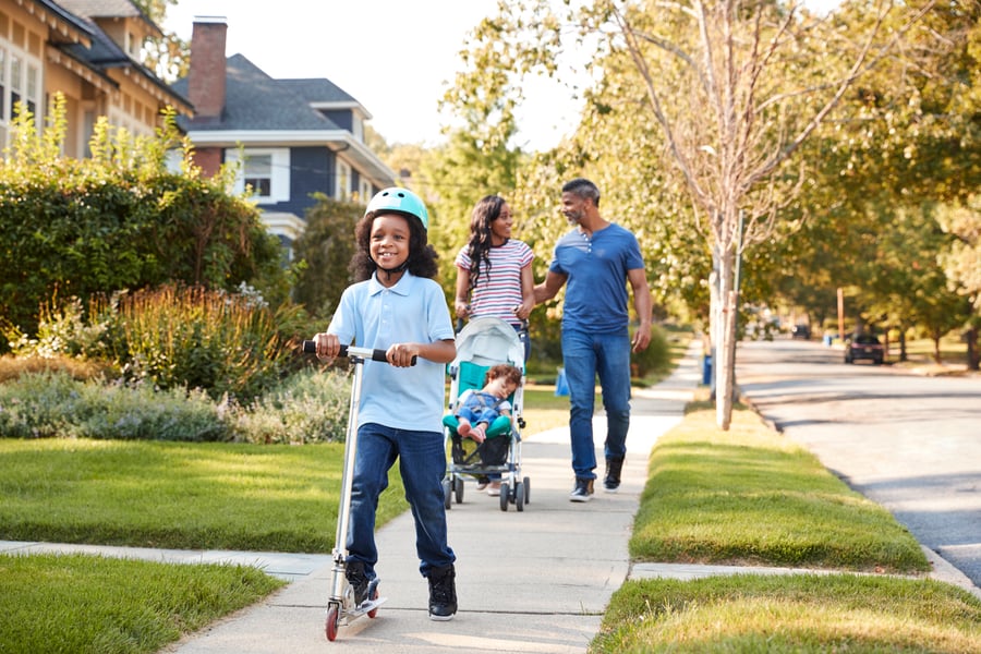 family on neighborhood sidewalk