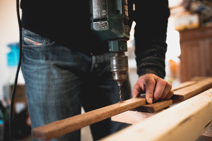 man using power drill for home project