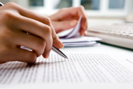 hand with pen signing lease documents