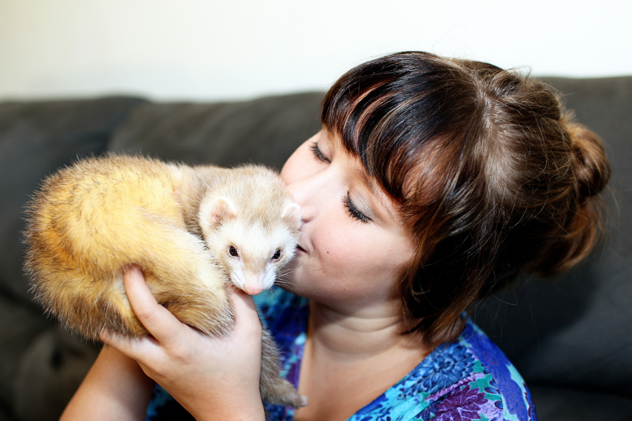 woman holding ferret 