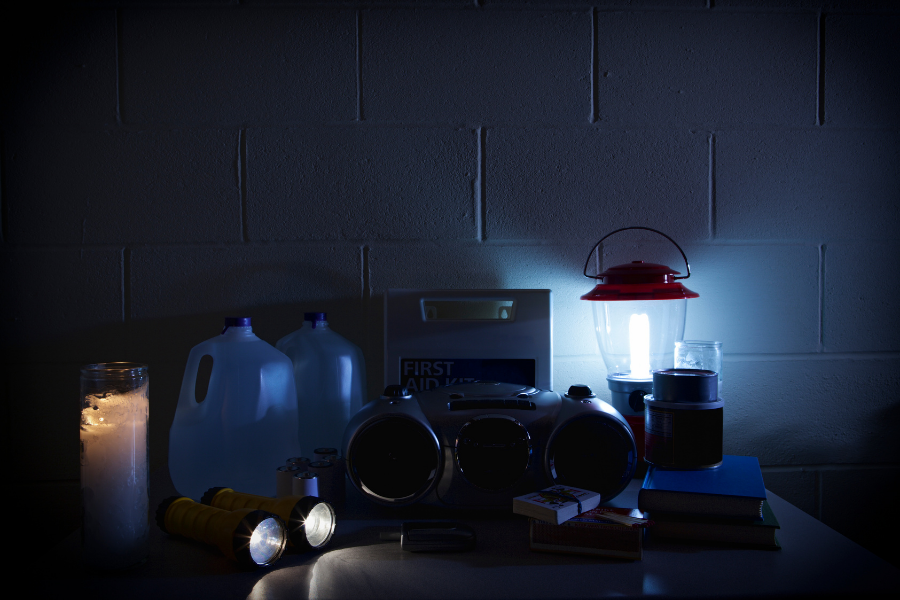 battery operated lamp, flashlights, jugs of water, and other supplies during power outage