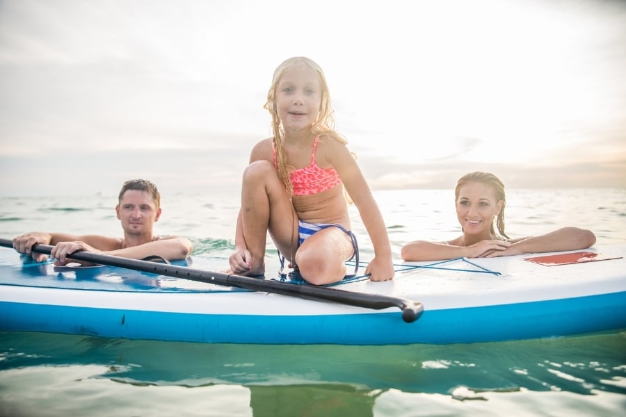 Family paddle-boarding in ocean in Florida