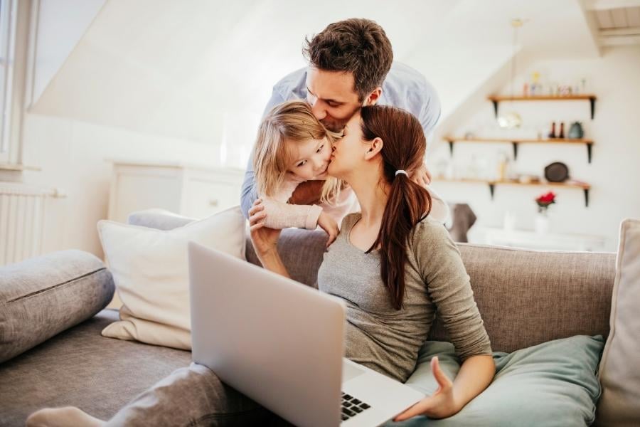 Family with laptop and couch