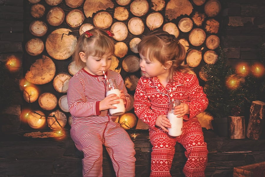 kids drinking milk in Christmas pajamas