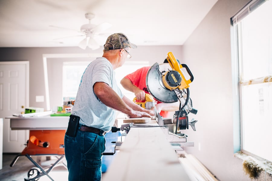 Two men with table saw making home improvements