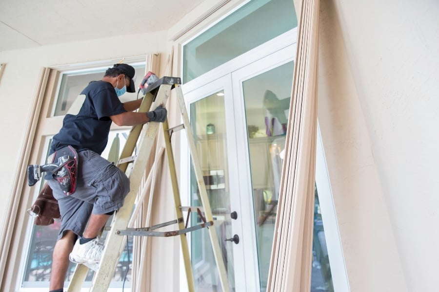 Man working on updating door to home.  