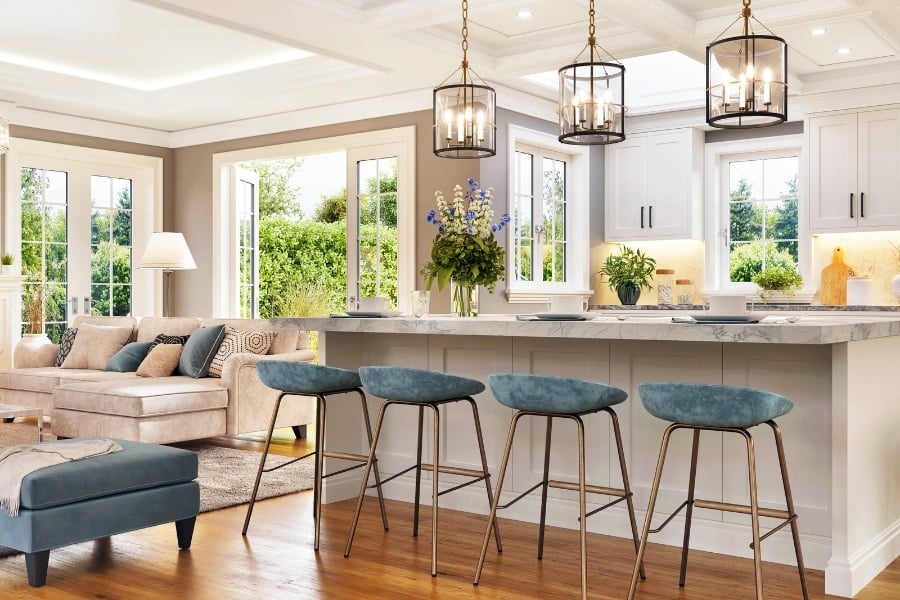 Staged home with fresh flowers, doors open, and blue accent furniture. 