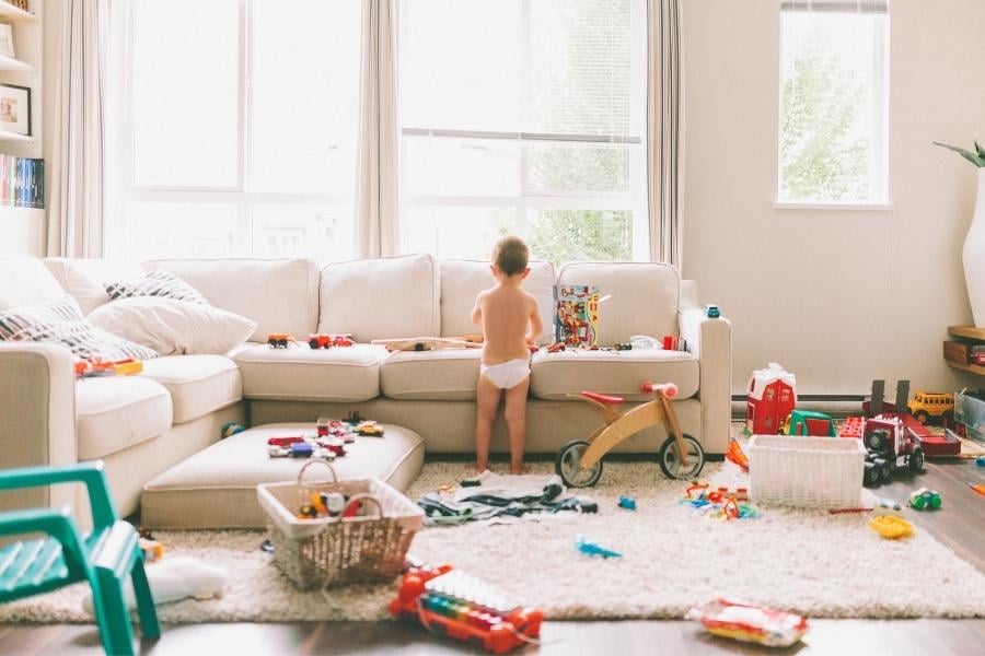 cluttered living room and child