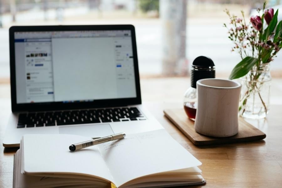 laptop and notebook on desk