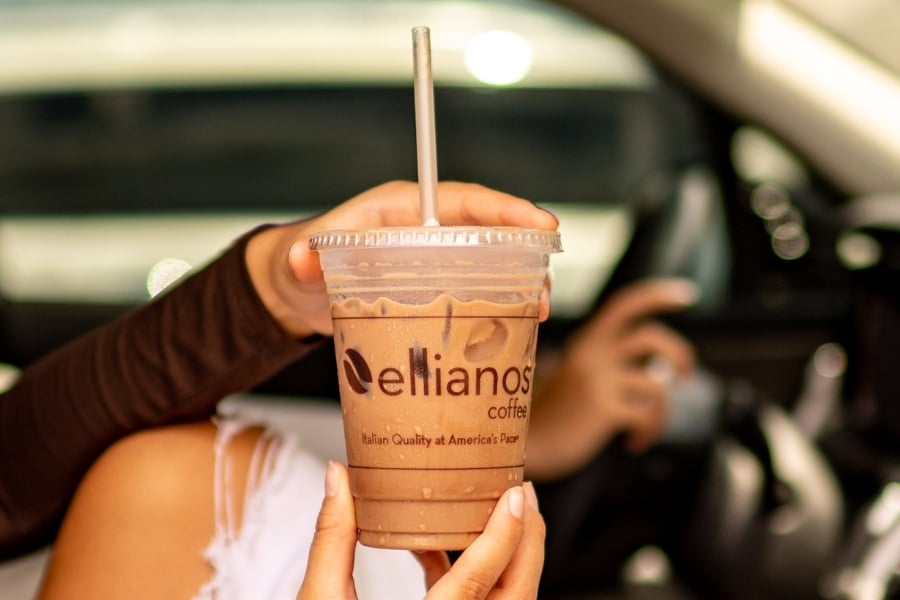 hand holding iced coffee with ellianos brand