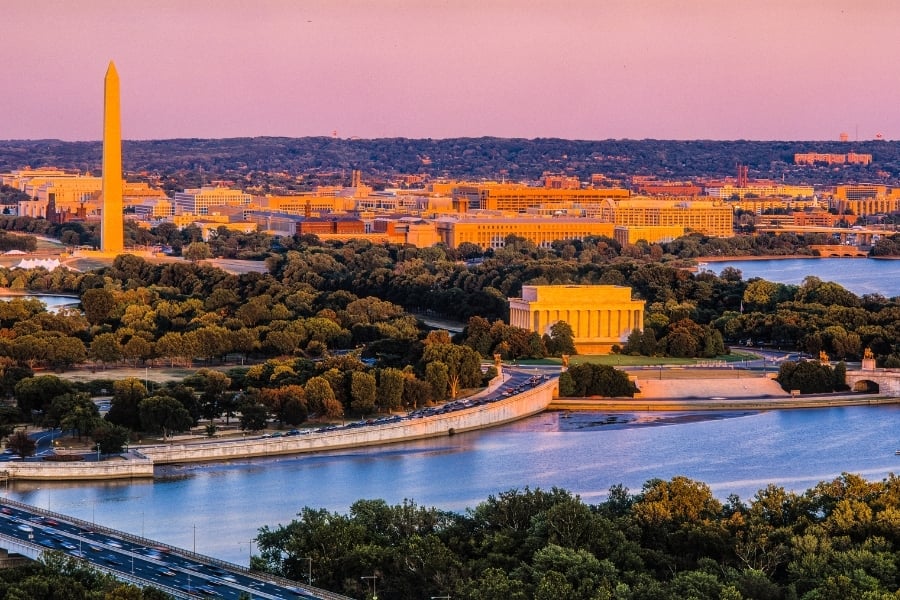 Aerial view of Washington, DC, and Potomac River at sunset with the Lincoln Memorial and the Washington monument in view. 