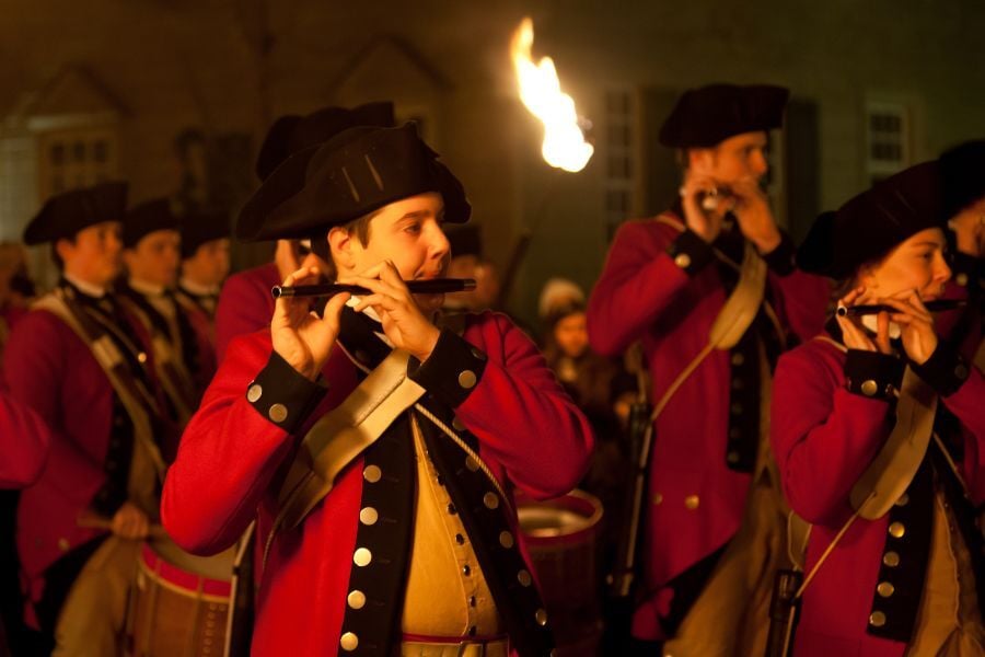 Red coat reenactment with torches and pipes in Colonial Williamsburg, Virginia