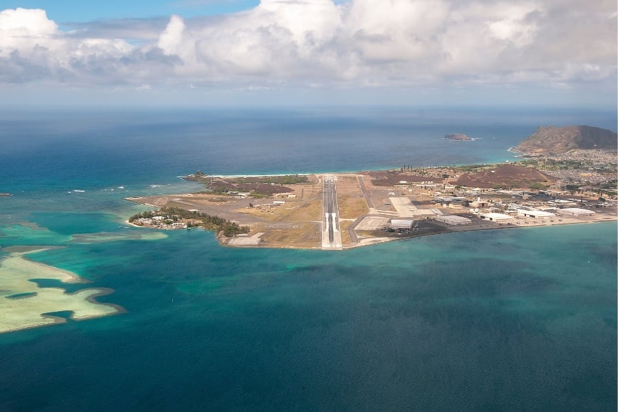 Aerial view of Marine Corps Base aerial view of Hawaii runway, ocean, clouds, and mountains in Kaneohe Hawaii 