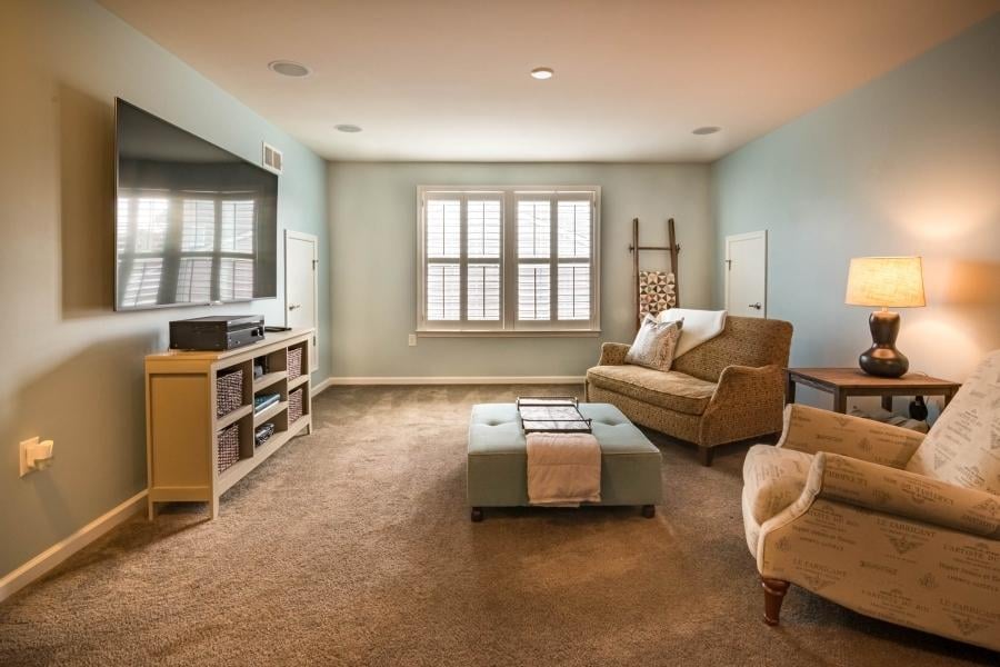 living room with couch chair and ottoman