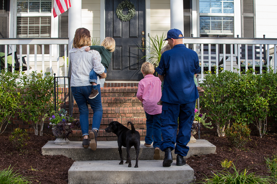 Coast Guard family with dog walking up steps