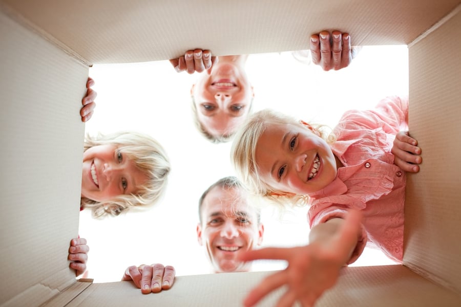 military family packing boxes to move into new home