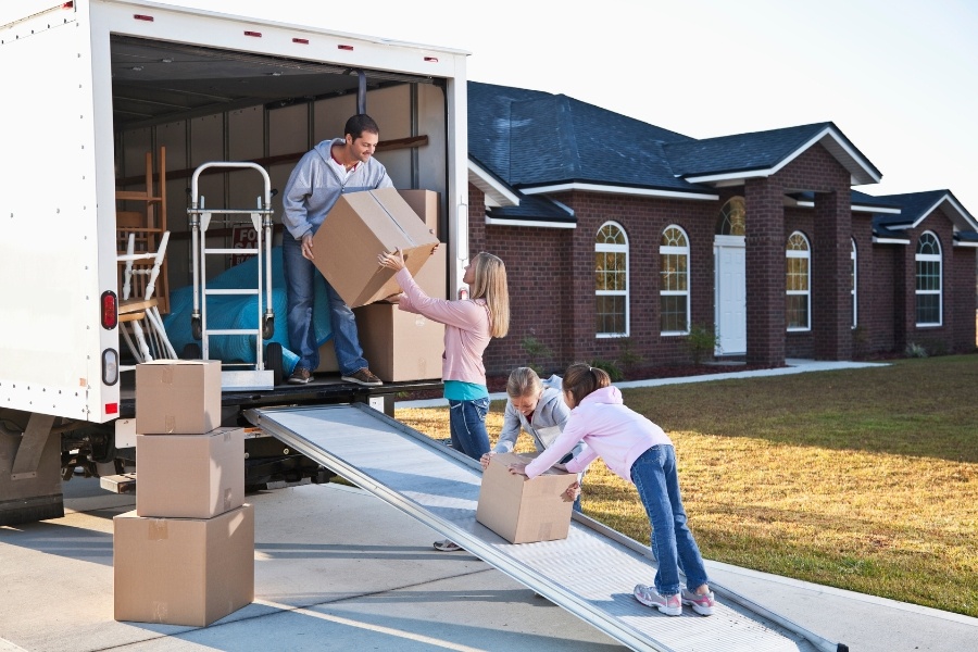 family loading belongings onto moving truck