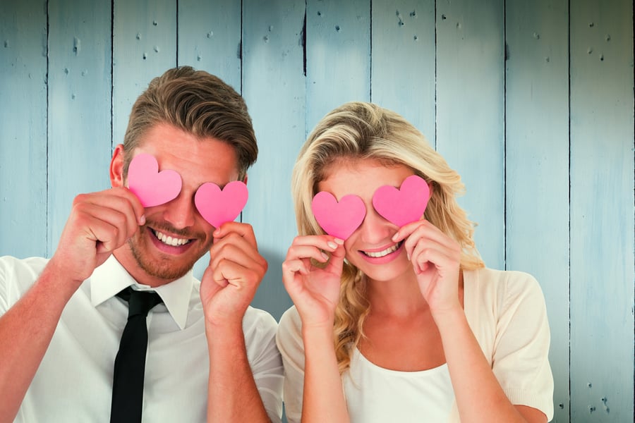 Couple holding paper hearts