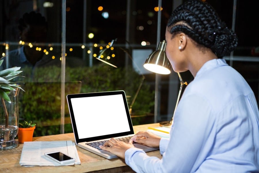 woman creating home sale listing online on her laptop