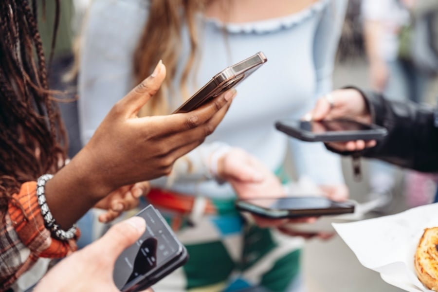People using phones to access social media. 