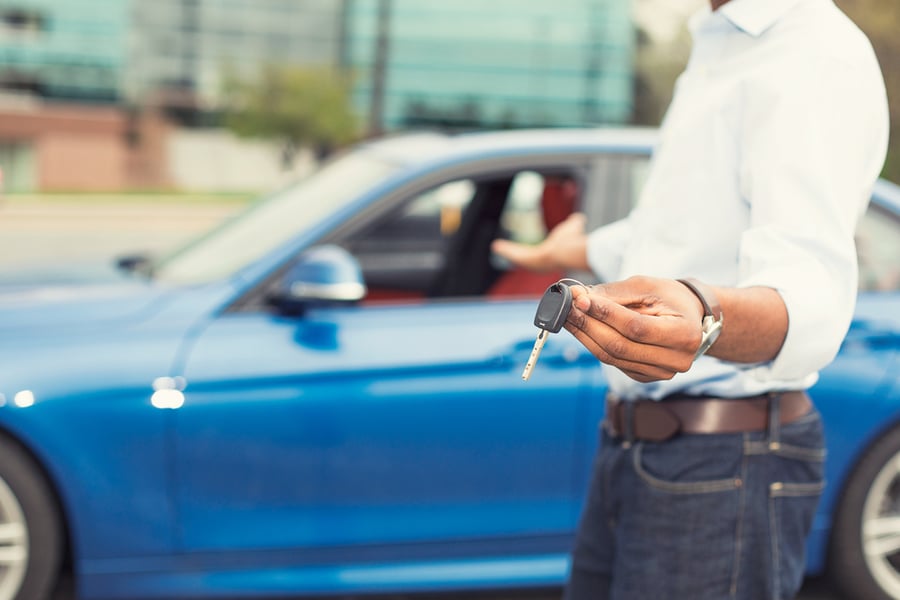 Man with keys to new car. 