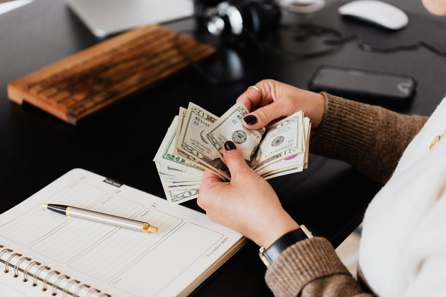 Woman holding money to pay pet deposit