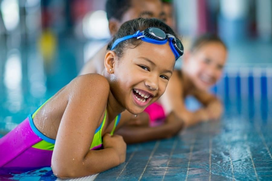 Children laughing at side of pool
