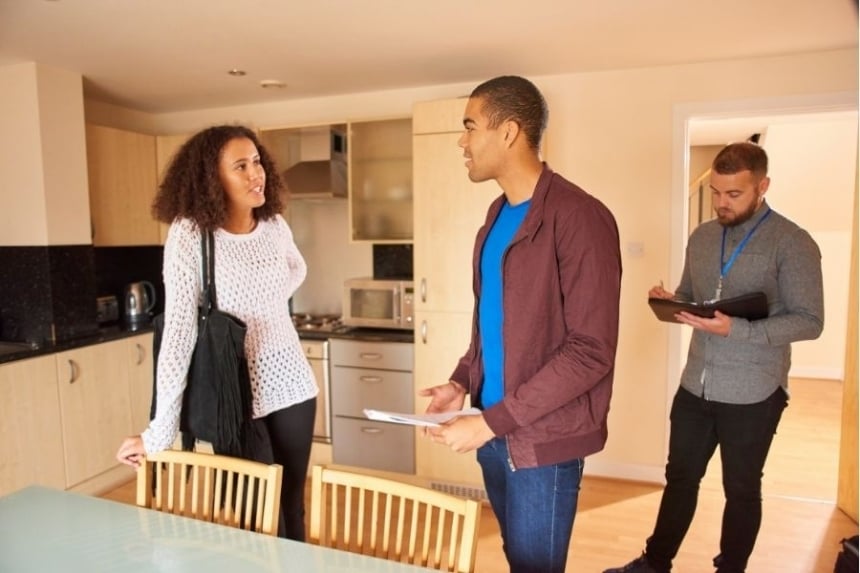 couple talking in home with realtor