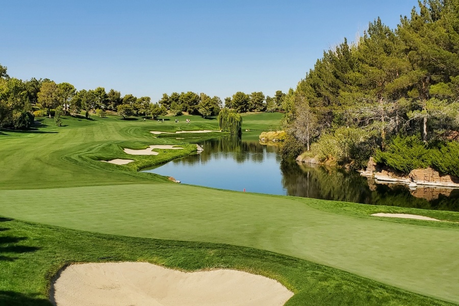 beautiful golf course with trees and lake