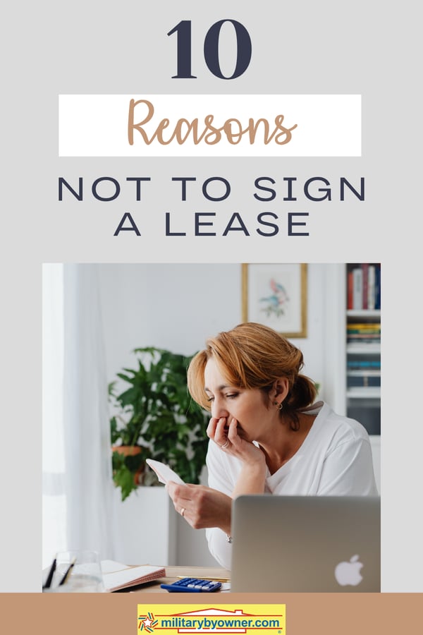 Woman sitting in front of computer with face in hand and text, 10 Reasons Not to Sign a Lease